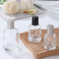 Venta al por mayor directa de fábrica: Botella de perfume redonda de vidrio transparente de 30ml, 50ml, 100ml con tapa y serigrafía para esmalte de uñas/aceite.