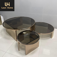 Table basse de luxe minimaliste en verre transparent ronde et moderne pieds en acier inoxydable