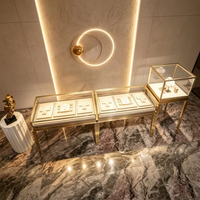 Comptoir de présentation de bijoux en acier inoxydable de luxe, vitrine en verre sur pieds hauts pour boutique de bijoux haut de gamme, vitrine vintage à LED