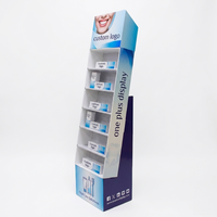 Présentoir en carton écologique pliable sur mesure à 4 étagères pour magasins de détail avec crochets pour dentifrice et brosse à dents