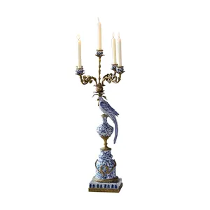 A beautiful parrot home decor candle holder made of porcelain and bronze and inspired by a vintage design ceramic candlestick