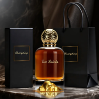 Flacon de parfum de luxe en verre transparent de 100 ml avec base en forme de montagne dorée et bouchon texturé pour emballage de marque