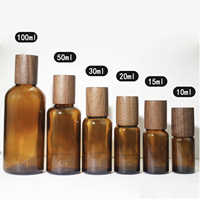 Botol Tetes Minyak Esensial Kaca dengan Tutup Sekrup Kayu Silinder Kustom, Permukaan Frost, Stamping Emas untuk Perawatan Kulit Krim Wajah