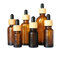 Botol bambu kaca Amber untuk minyak esensial 15ml-100ml ukuran dengan penetes kayu dan cetakan layar untuk tetes mata