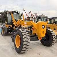 Niveleuse sur pneus Caterpillar CAT 140K en bon état avec moteur C7 ACERT
