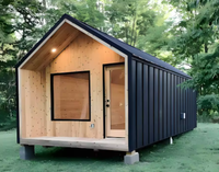 Sauna finlandais extérieur en forme de maison noire avec poêle électronique, design moderne et écologique, en bois, avec toit pour jardin