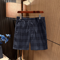 Shorts cinq-quarts à carreaux noirs et blancs, coupe droite décontractée, style luxe léger et tendance pour homme, idéal pour l'été