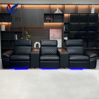 Fauteuil inclinable électrique noir en microfibre pour salon, style moderne, avec fonction massage et extension, idéal pour home cinéma