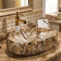Lavabo ovale en céramique à texture marbre naturel de luxe, lavabo artistique à poser sur comptoir pour projets hôteliers et villas haut de gamme