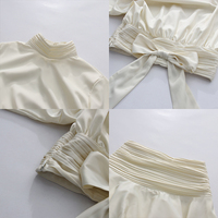 Ensemble deux pièces chic abricot pour femme, haut à col montant et manches bouffantes avec nœud, jupe fluide froncée taille haute, style minimaliste et élégant pour soirée, vente en gros