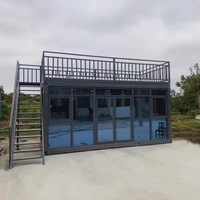 Maison conteneur démontable à installation rapide avec mur-rideau en verre pour bureau mobile de luxe sur chantier