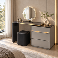 Table de toilette pour le maquillage avec miroir rond orné de pierres, panneau en verre noir, tiroirs à bordure dorée pour chambre à coucher, maison et salon de beauté