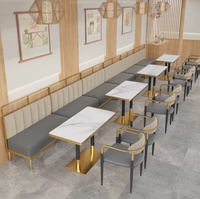 Ensemble de salle à manger au design moderne haut de gamme pour restaurant occidental Table en pierre de luxe avec cadre en métal doré Chaises en cuir de haute qualité
