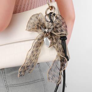 พวงกุญแจจี้กระเป๋าแบบตาข่ายประดับโบว์ผีเสื้อมุกและหัวใจสไตล์เกาหลียอดนิยมของ Mengda ทำด้วยมือ - Product Image 3