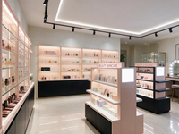 Présentoir de Cosmétiques Multi-Faces pour Magasin, Îlot d'Exposition Blanc avec Étagères Rétroéclairées, Vitrine Lumineuse à Cadre Foncé, Meuble de Rangement Autoportant Type Gondole