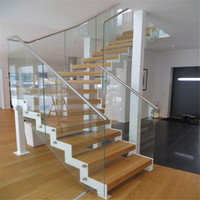 Escalier flottant moderne en bois avec rampe en verre sur mesure pour projets résidentiels