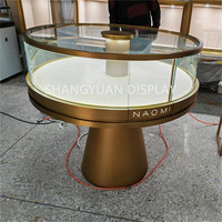 Table d'affichage de bijoux en or incurvée haut de gamme Boutique en verre rond de luxe vitrine de comptoir de magasin de bijoux moderne pour bijouterie