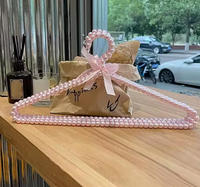 Cintre en tissu rose nacré pour vêtements, vente en gros, best-seller pour les magasins de vêtements