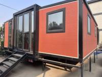 Maison conteneur extensible moderne Zhanshun de 20 pieds avec mur rideau en verre, véranda carrée noire, design de mini-maison, garantie 1 an