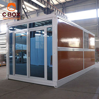 Maison pliable en bois grainé Cbox avec porte coulissante en verre, maison préfabriquée modulaire en conteneur pliable