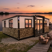 Maison conteneur préfabriquée extensible, revêtement extérieur blanc, placage en pierre, structure en acier noir, villa moderne, cabane, vente en gros directe d'usine