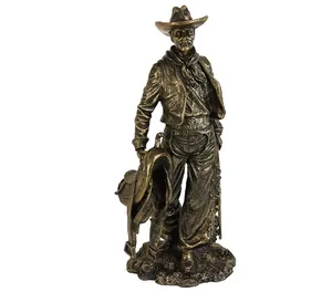 Resin statues of western cowboys holding saddles and rifles. Old World Wild West cowboy country themed statue