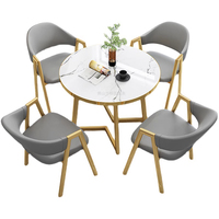 Ensemble de table et de chaises de salle à manger en métal de luxe moderne pour les cafés et les salons de thé