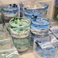 Bougie parfumée en verre sur le thème de l'océan, avec coquillages naturels, sable fin, fleurs bleues séchées et paysage tridimensionnel décoratif en cire parfumée