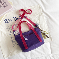 Sac bandoulière décontracté en nylon color block pour femme, grande capacité, avec pendentif et bandoulière large détachable, idéal pour les trajets quotidiens