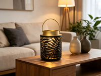 Lanterne en métal ajourée à motif de feuille noire, lanterne décorative portable en fer avec bordure dorée, option d'éclairage LED personnalisable