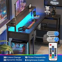 Bureau de jeu d'ordinateur en forme de L avec prises de courant et lumières LED Support de moniteur et étagère de rangement Bureau d'angle pour bureau à domicile