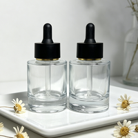 Système compte-gouttes en verre premium 30 ml avec capuchon noir mat et emballage carton pour crème visage et collyre