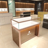 Mostrador de tienda minorista de oro de lujo, mesa de exhibición de diseño, joyería, muebles, escaparates de joyería de cristal, luces Led