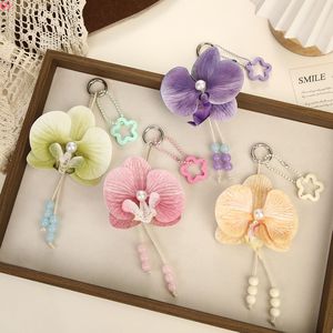 Llavero de PVC con flor de orquídea, diseño tierno, adornado con cuentas de perlas y un dije en forma de estrella; souvenir a - Product Image 1
