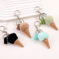 Nouveau porte-clés et pendentif de téléphone créatif semi-artisanal en forme de crème pour femme, collection automne/hiver, avec pompon