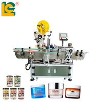 Machine d'étiquetage automatique à 2 têtes pour l'application d'étiquettes sur le dessus et les côtés des bouteilles rondes de cosmétiques et d'aliments