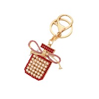 Porte-clés pendentif exquis en métal avec nœud, pompon, perle et flacon de parfum, petit cadeau