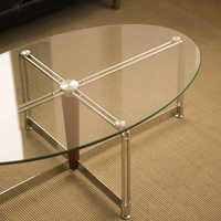 Table basse convertible ovale en verre trempé, style industriel nordique moderne, avec rangement et structure en métal noir mat durable
