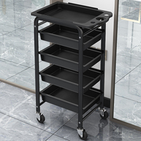 Chariot de rangement multifonctionnel moderne noir et or pour salon de manucure, équipement de coiffure et de beauté, avec roulettes