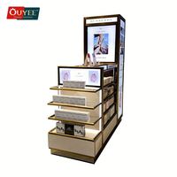 Kiosque de présentation de parfums moderne blanc pliable et rotatif avec étagères en métal et en verre
