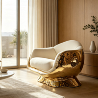 Fauteuil lounge en fibre de verre plaqué or, rembourré en tissu, avec accoudoirs courbes, pour la décoration de villas, d'hôtels et de halls d'entrée.
