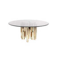 Table à manger italienne de luxe en marbre avec un dessus rotatif et une base en métal irrégulière adaptée au salon