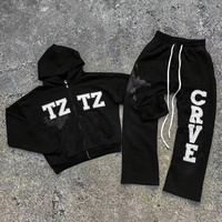 Ensemble de survêtement hiver Y2K foncé en molleton, comprenant un sweat à capuche zippé et un pantalon de jogging ample à poches, avec imprimé effet éclaboussures et fissures vieillis