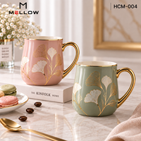 Ensemble de 2 tasses à café en porcelaine avec poignée dorée et bordure dorée, motif feuille de Ginkgo rose et verte, pour couple, idéal pour les boutiques lifestyle (OEM)