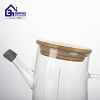 Fournisseur de Chine bouteille d'huile à haute teneur en borosilicate avec couvercle en bois bocaux de stockage d'huile de marché de dinde à faible quantité minimale de commande avec bec en silicone