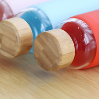 Bouteille en verre à haute teneur en Borosilicate avec couvercle en bambou et manchon en Silicone, bouteille d'eau en verre avec couvercles en bambou en bois, vente en gros