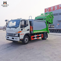 Camion compacteur de déchets HEAVSTY 7 mètres cubes 4x2 à transmission manuelle et chargement arrière, moteur et boîte de vitesses pour bacs de 120L/240L