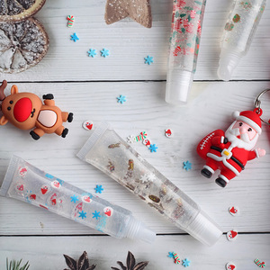 Brillo labial navideño Herorange en tubo transparente con diseño de renos y Santa Claus con brillantina, ideal para regalo navideño. - Product Image 1