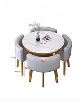 Table à manger ronde de luxe légère avec cadre doré et chaises rembourrées pour salon