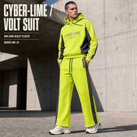 Ensemble de survêtement 2 pièces en molleton 500 GSM Acid Lime, comprenant un sweat à capuche court color block et un pantalon de survêtement à ourlet évasé à micro-clous, style streetwear, avec logo personnalisé